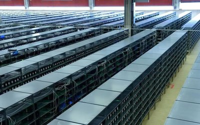 A large cryptocurrency mining farm with numerous mining rigs operating.